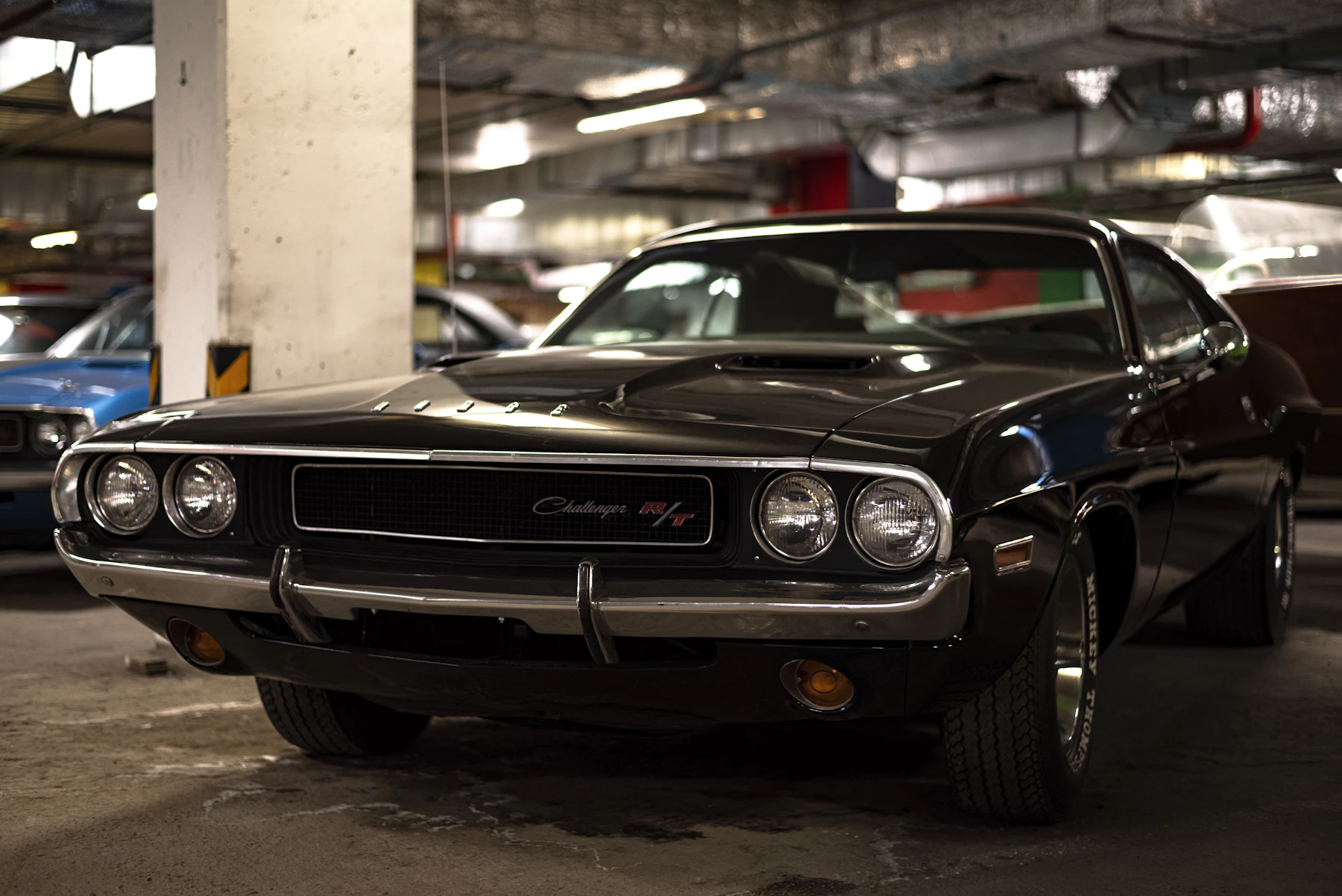 Black car parked in an indoor garage