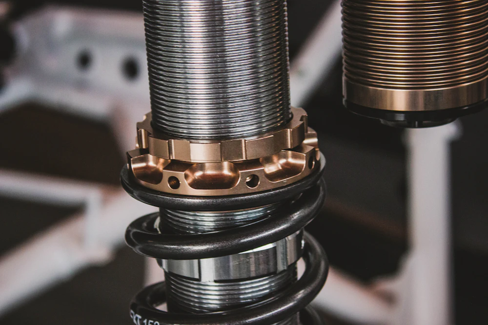 Close-up of a vehicle shock absorber and coil spring